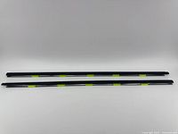 Two black door weather strip window belt seals laid parallel on a plain background, showcasing length and shape.