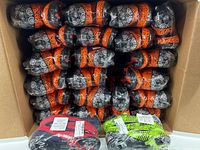 Box with around 30 pairs of Mandala Pattern Soccer Cleats in original packaging showing black with orange and black and neon green designs.