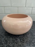 Front view of the peach round ceramic vase with glossy finish