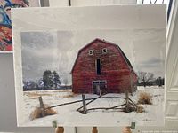 Photo of 16x20 photograph wrapped in plastic showing the old red barn in a snowy field with fence and grasses.