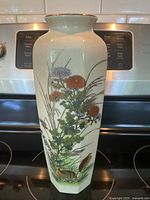 Full view of tall 11-inch ceramic Japanese vase with detailed floral and bird artwork and crackled glaze finish