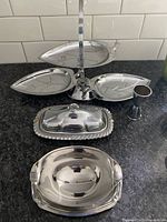 Full view of the silver tone serving set showing the three-tiered leaf shaped serving tray, rectangular covered dish, round dish, and egg cup.