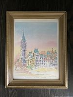 Lightly used framed watercolour print showing Parliament Buildings with a tall clock tower and surrounding buildings in pastel colors. Signed by Diane Arnold in the lower right.