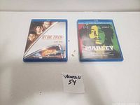 Image showing two Blu-ray/DVD combo packs: Star Trek and Marley documentary, placed side by side on a white surface.