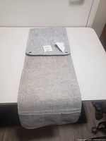 Full view of gray felt couch armrest organizer showing overall form and structure