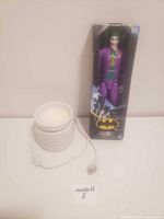 Joker figure and incense plug-in side by side with cord visible, showing both items included in lot