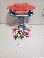 Front view of Paw Patrol lookout tower playset with five metal vehicles arranged in front.