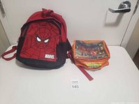 Full view of Spider-Man kids backpack and vintage Spider-Man lunch kit placed on a white surface.