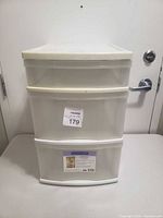 Front view showing three drawers with translucent fronts and a white lid top.