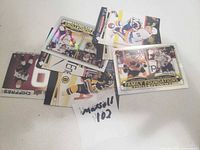 Photo of approximately fifteen loose Tim Hortons hockey cards with players in various NHL team jerseys, laid out on a white surface.