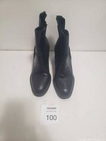 Front view of the black ankle boots, showing the toe shape and overall condition.