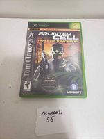 Front cover of the Xbox game case showing artwork and title for Tom Clancy's Splinter Cell Pandora Tomorrow.