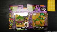 Shows two sealed TMNT Mutant Mayhem figures: Genghis Frog and Turtle Tots (Raph & Mikey).