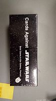 Photo of a sealed Boxes Against Star Wars game box, showing the front with white text on a black starry background.