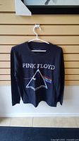 Black long sleeve Pink Floyd shirt with iconic prism and rainbow light graphic.