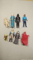 Lot photo of 8 vintage Star Wars figures showing various characters and wear