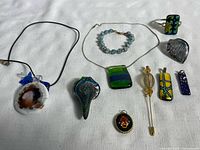 Full assortment of jewelry items and accessories on white cloth background.