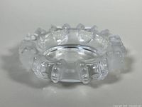 View of crystal ashtray showing octopus tentacles around rim with frosted detail and clear bowl interior.