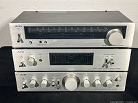 Front view of three stacked Aurex components showing overall condition and matching faceplate finish