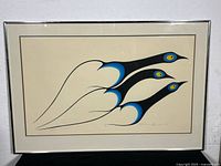 Full view of framed serigraph print showing three stylized birds flying, mostly black and blue on cream background