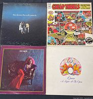 Top view of four vinyl record albums: The Doors - The Soft Parade, Big Brother & The Holding Company - Cheap Thrills with Janis Joplin, Janis Joplin - Pearl, and Queen - A Night At The Opera.