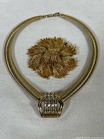 Monet brooch and Nina Ricci choker necklace together showing overall appearance and size relation.