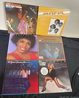 Photo of six vinyl record albums including Ike & Tina Turner Live in Paris, The Temptations Greatest Hits, Gladys Knight, Otis Redding The Dock of the Bay, Al Green's Greatest Hits Volume 3, and Tina Turner's Private Dancer.