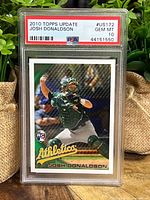 Front photo of Josh Donaldson 2010 Topps rookie card in PSA slab grade 10 gem mint showing the player in catcher pose with Oakland Athletics logo and rookie card insignia.