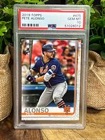 Front of 2019 Topps Pete Alonso rookie baseball card graded PSA 10 Gem Mint in protective slab showing batting pose in Mets uniform.