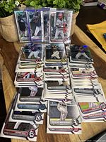 Overview of multiple stacks of Bowman 1st Refractor baseball cards featuring various players and teams.