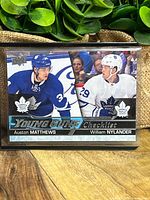 Front of the hockey card showing Auston Matthews and William Nylander in Toronto Maple Leafs uniforms with Young Guns Checklist branding.