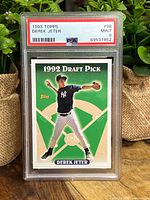 Front view of the 1993 Topps Derek Jeter rookie card graded PSA 9 Mint, showing Derek Jeter in pitching pose with green background and grading label at top.