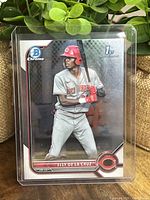 Front view of Elly De La Cruz Bowman Chrome 1st card with player in batting pose, card encased in plastic holder.