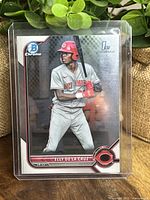 Front view of Elly De La Cruz baseball card in protective plastic holder showing player image and card details.