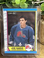 Front of Joe Sakic rookie hockey card showing player in Quebec Nordiques jersey with O-Pee-Chee branding.