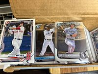 Box with stacks of Bowman MLB baseball cards, showing players Marcelo Mayer, Kahleel Watson, Colson Montgomery on front cards.