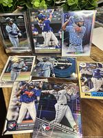 Photo showing eight Vladimir Guerrero Jr. baseball cards from 2019-2023 with various poses and designs, including rookie cards and different Topps series.