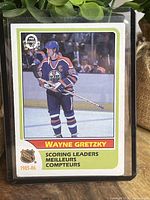 Front side of hockey card featuring Wayne Gretzky in Oilers uniform, labeled 'Scoring Leaders' for the 1985-86 season.