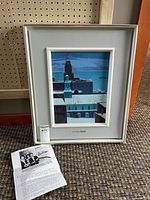 Painting in frame with informational sheet