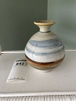 Front view of the vase showing the full shape, colors, and signature area