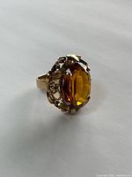 Ring angled to show stone color, cut facets, and setting design