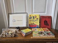 Full lot overview showing wooden puzzle pieces in bag, multiple vintage children's books including '5-Minute Berenstain Bears Stories' and 'Jungle Book'