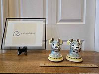Pair of Lefton Disney Lady and the Tramp dog ceramic bookends side by side with a ruler for size reference.