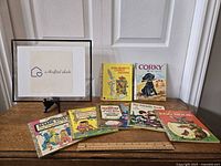 Photo of nine vintage Golden Books arranged on a flat surface showing cover illustrations of Sesame Street, Bugs Bunny's Carrot Machine, Corky the Puppy and other titles.
