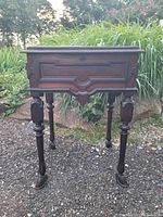 Overview of the Victorian sewing desk showing body, legs, and claw feet.
