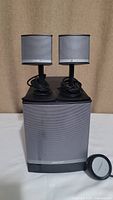 Complete Bose Companion 3 Series II speaker system showing two satellite speakers mounted on stands, subwoofer with stain on front, and inline control unit with cables.