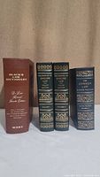 Four hardcover law books standing upright: Black's Law Dictionary, two volumes of The History of English Law, and The Common Law & Other Writings.