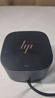 Top view of the black HP electronic dock with HP logo visible on top surface.