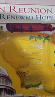 Close-up of the Peter Max artist signature with prominent yellow brush stroke and part of text above.
