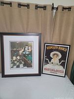 Two framed Martini & Rossi prints displayed side by side. Left is the signed and numbered limited edition print showing a bar scene with two people at a pool table. Right is the Vermouth Bianco promotional print with a woman in a white hat.